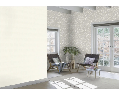 Pièce lumineuse avec papier peint à motifs, fauteuils et plante d''intérieur