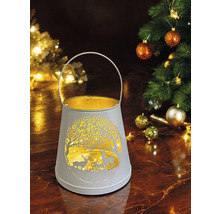 Lanterne décorative avec motif de cerf et motif d''arbre à côté d''un arbre de Noël décoré.