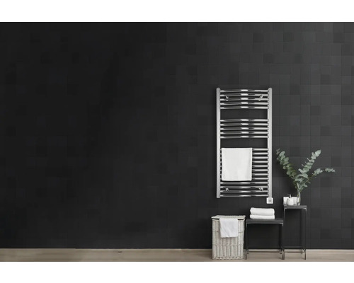 Salle de bains moderne avec sèche-serviettes, panier à linge et décoration