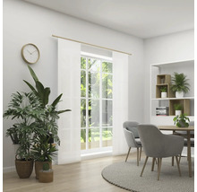 Salle à manger lumineuse avec table, chaises, plantes, horloge et rideaux transparents