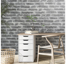 Bureau avec bureau, chaise et mur de briques