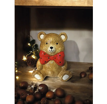 Décoration ours en peluche avec nœud sur une étagère en bois