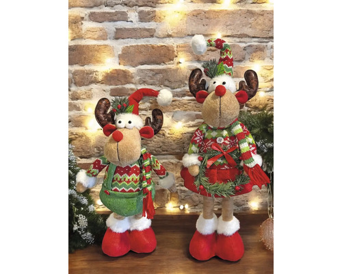 Zwei dekorative Rentierfiguren vor einer Ziegelwand