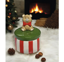 Dekorative Dose mit Bärenfigur auf einem Weihnachtstisch