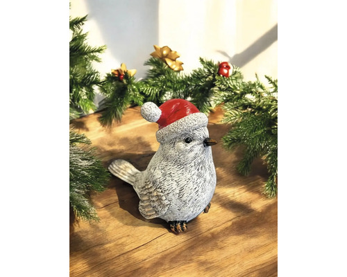Dekorative Vogelfigur mit Weihnachtsmütze als Weihnachtsdekoration