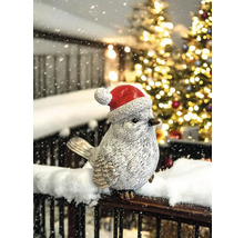 Figurine d''oiseau décorative avec bonnet de Noël dans un environnement hivernal