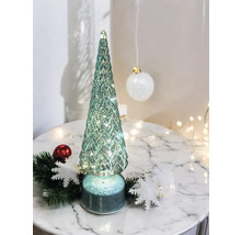 Sapin de Noël décoratif en verre avec éclairage sur une table