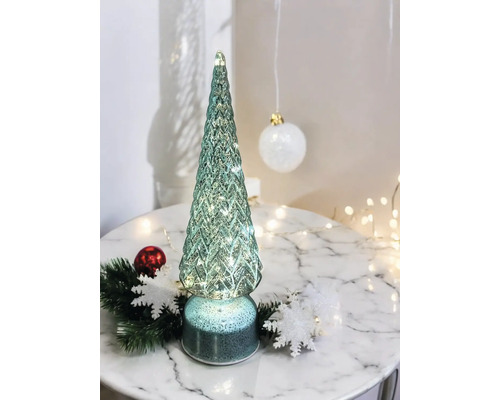 Sapin de Noël décoratif en verre avec éclairage sur une table