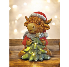 Figurine décorative de vache avec bonnet de Noël et sapin de Noël avec des lumières.
