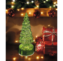 Sapin de Noël décoratif en verre vert avec des boîtes cadeaux en arrière-plan comme décoration festive.