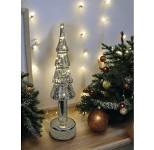Sapin de Noël décoratif en verre avec éclairage à côté d''un sapin de Noël décoré