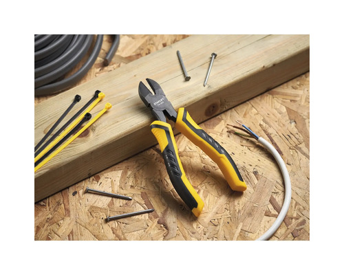 Pince coupante avec serre-câbles, clous et câble sur fond en bois