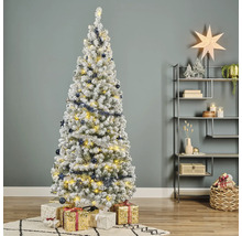 Sapin de Noël décoré et enneigé avec des cadeaux dans le salon
