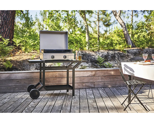 Photo extérieure d''un barbecue à gaz avec chariot de barbecue sur une terrasse.
