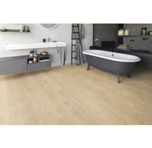 Salle de bains avec baignoire îlot, lavabo et plancher en bois clair