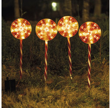 Vier leuchtende Solar-Lutscher als Gartenstecker im Gras