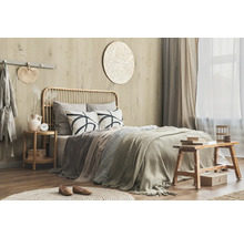 Schlafzimmer mit Bett, Nachttisch und dekorativen Elementen in warmen Farbtönen für eine gemütliche Atmosphäre.