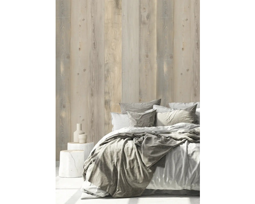 Helles Schlafzimmer mit Holzwand und Bett