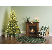 Scène de Noël avec sapin, cheminée et fauteuil dans un salon confortable