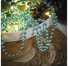 Arrangement décoratif avec guirlande de perles, guirlande lumineuse et pommes de pin