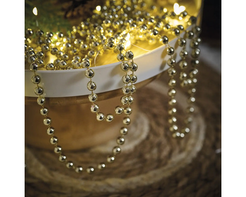Guirlande de perles dorées pour la décoration dans un bol