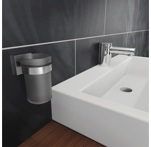 Detailaufnahme eines Waschbeckens mit Armatur und Zahnputzbecherhalter im Badezimmer