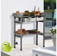 Table de rempotage grise avec étagères et accessoires de jardin