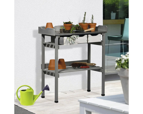 Table de rempotage grise avec étagères et accessoires de jardin