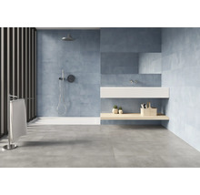 Salle de bains lumineuse avec douche, lavabo et carrelage gris au sol.
