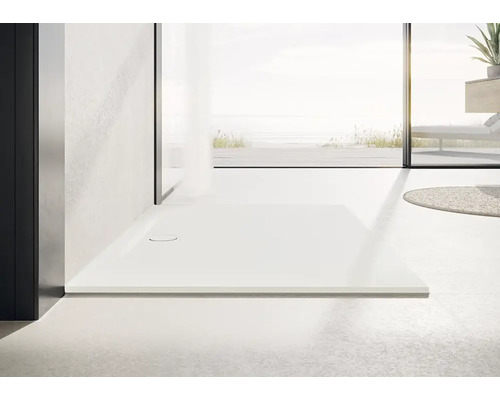 Receveur de douche plain-pied dans une salle de bains lumineuse.