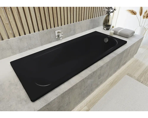 Baignoire noire dans une salle de bain avec des éléments décoratifs