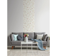 Salon avec canapé gris, table blanche et papier peint à fleurs