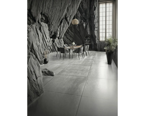 Salle à manger avec table, chaises et design mural original aspect roche.