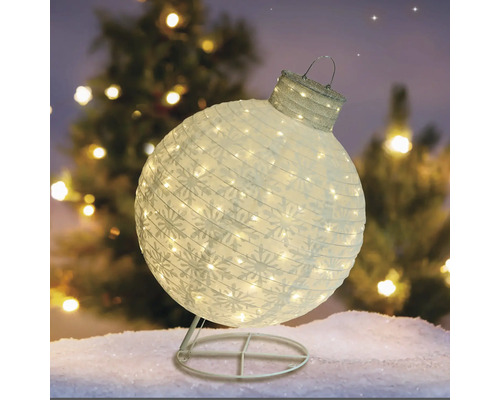 Dekorative, beleuchtete Weihnachtskugel mit Schneeflockenmuster auf einem Ständer
