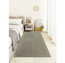 Chambre avec lit et tapis gris à motifs