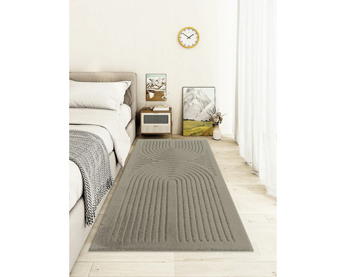 Chambre avec lit et tapis gris à motifs