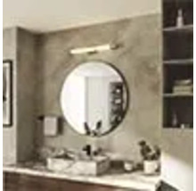 Salle de bains avec miroir rond, lavabo et étagère