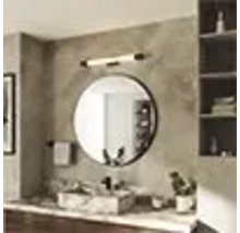 Salle de bain avec miroir rond, lavabo et éclairage