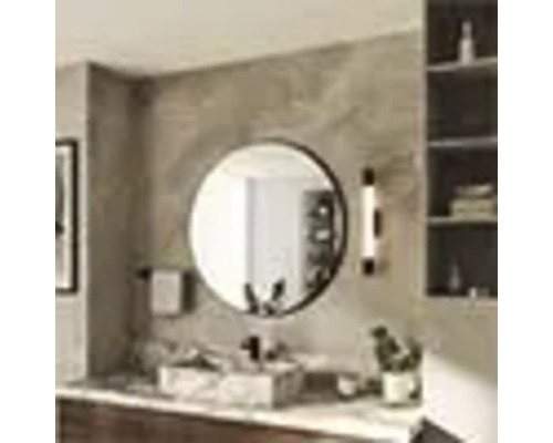 Salle de bains moderne avec miroir rond au-dessus d'un lavabo