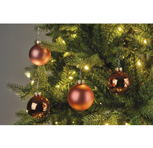 Nahaufnahme von Weihnachtskugeln an einem Weihnachtsbaum mit Beleuchtung.