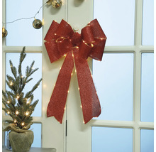 Dekorativer Weihnachtsschmuck mit Schleife und Mini-Weihnachtsbaum