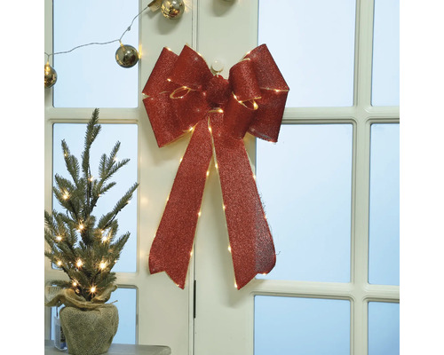 Dekorativer Weihnachtsschmuck mit Schleife und Mini-Weihnachtsbaum