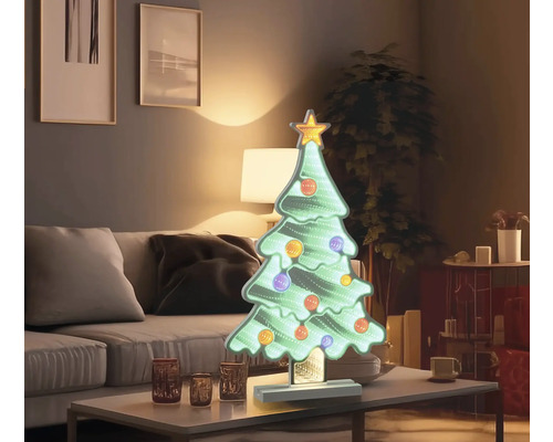 Sapin de Noël décoratif avec étoile et boules sur table