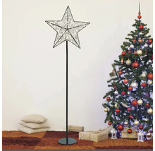 Dekorative Stern Stehlampe neben einem geschmückten Weihnachtsbaum.