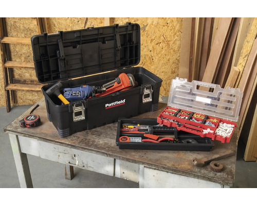 Geöffnete Werkzeugkiste mit Werkzeugen und Kleinteilesortiment auf einem Tisch.