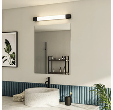 Salle de bains moderne avec lavabo, miroir et applique murale