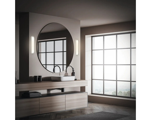 Modernes Badezimmer mit grossem Spiegel, Waschtisch und Fenster.