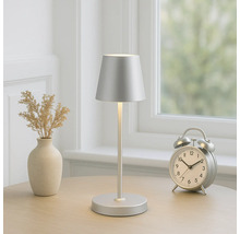 Dekorative Tischleuchte aus Metall mit Lampenschirm auf einem Tisch