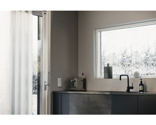 Cuisine moderne avec fenêtre, évier, robinet et divers accessoires de cuisine