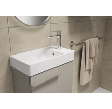 Meuble-lavabo avec armoire, robinet et porte-serviettes dans la salle de bains